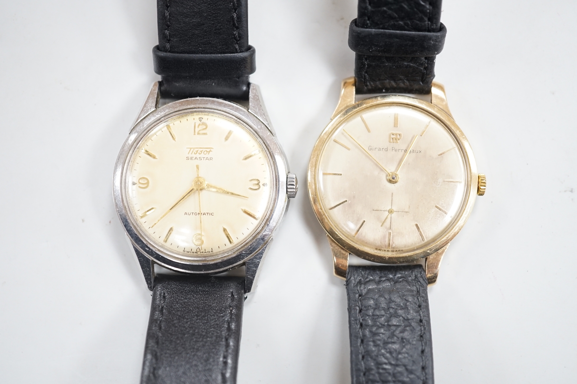 A gentleman's 9ct gold Girard Perregaux manual wind wrist watch, on associated leather strap and a gentleman's stainless steel Tissot Seastar automatic wrist watch.